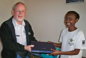 Cliff presenting one of our college students, Eskedar, with a laptop to help her in her education.